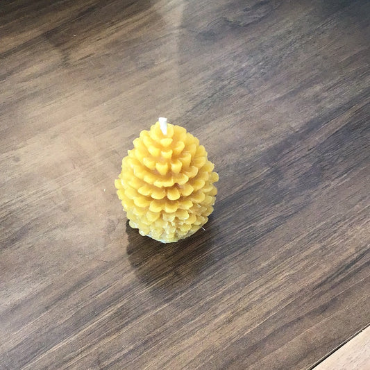 Teeny tiny pine cone beeswax candle